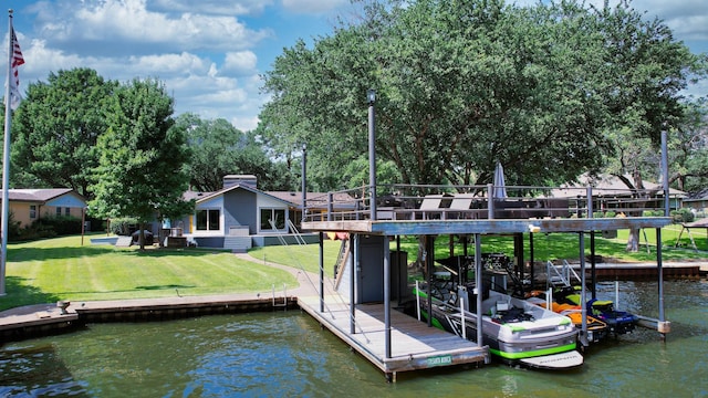 view of dock with a deck with water view and a lawn