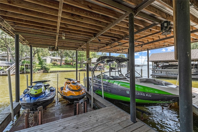 dock area with a water view and boat lift