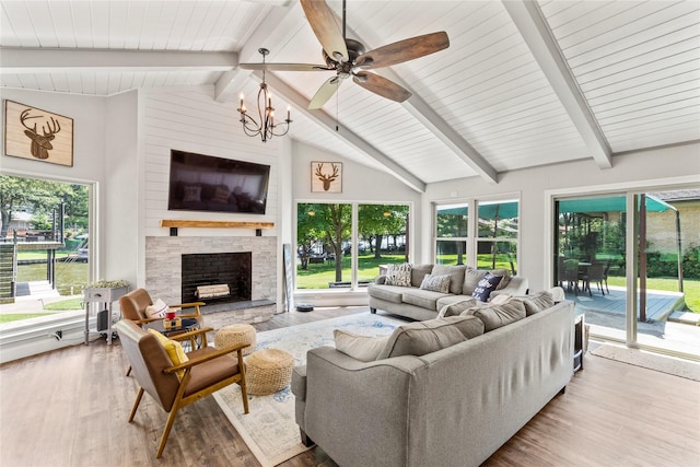 sunroom with vaulted ceiling with beams, a fireplace, and a notable chandelier