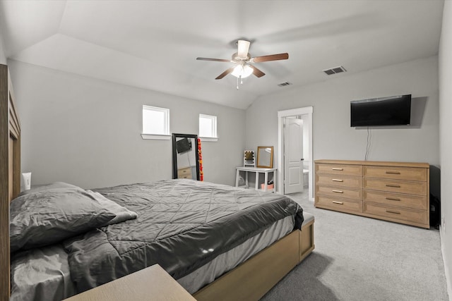bedroom featuring vaulted ceiling, light carpet, visible vents, and a ceiling fan