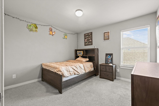bedroom featuring baseboards and light colored carpet