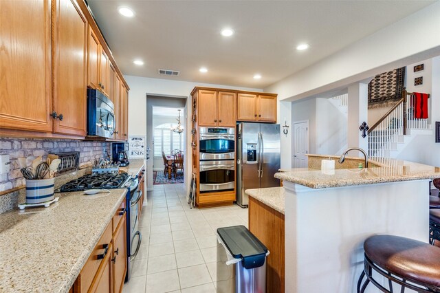 kitchen with visible vents, backsplash, recessed lighting, appliances with stainless steel finishes, and light tile patterned floors