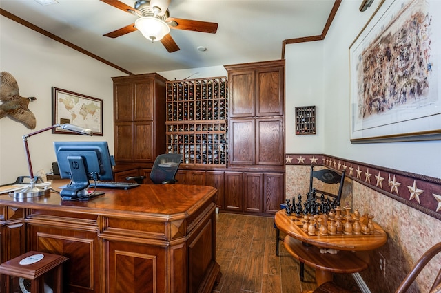 office area with dark wood finished floors, crown molding, wainscoting, and ceiling fan