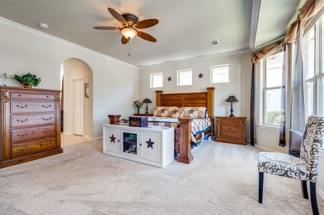 8912 Landmark Ln, Denton, TX 76207 - bedroom with arched walkways, light carpet, ornamental molding, multiple windows, and baseboards