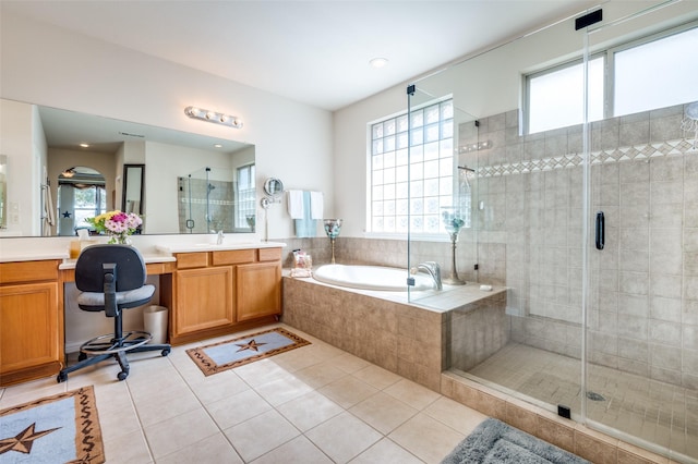 full bath with tile patterned flooring, a shower stall, a garden tub, and vanity