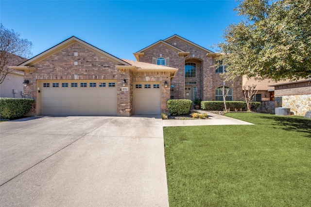 view of front of property featuring brick siding, concrete driveway, central AC, a front yard, and an attached garage