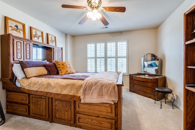 bedroom featuring light carpet, visible vents, ceiling fan, and baseboards