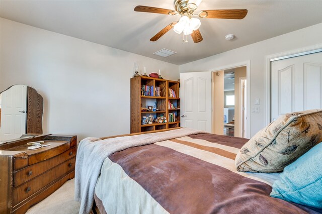 carpeted bedroom with visible vents and ceiling fan