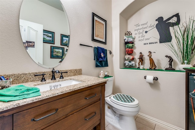 bathroom featuring tile patterned flooring, toilet, and vanity