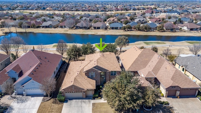 birds eye view of property featuring a residential view and a water view