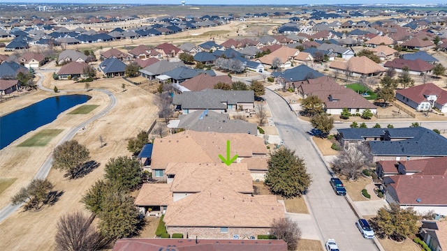 birds eye view of property with a residential view and a water view