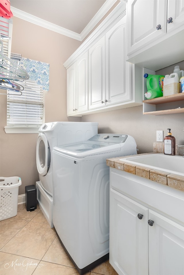162 Captain Hm Shreve, Shreveport, LA 71115 - laundry area featuring washer and clothes dryer, cabinet space, crown molding, and light tile patterned flooring