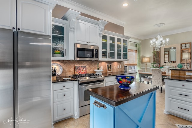 162 Captain Hm Shreve, Shreveport, LA 71115 - kitchen with stainless steel appliances, glass insert cabinets, white cabinetry, backsplash, and ornamental molding