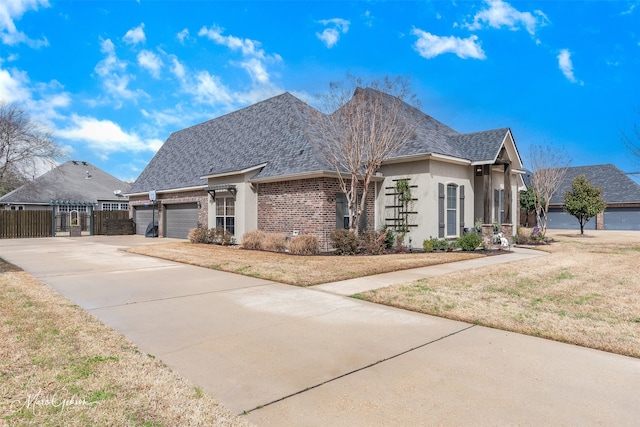 162 Captain Hm Shreve, Shreveport, LA 71115 - view of property exterior with a garage, driveway, brick siding, stucco siding, and roof with shingles