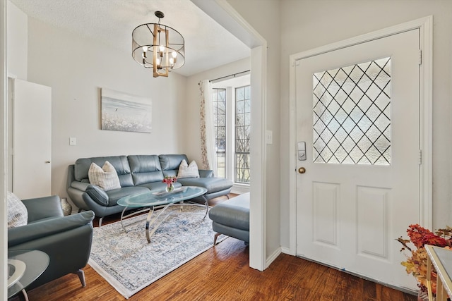 interior space with dark wood-style floors and an inviting chandelier