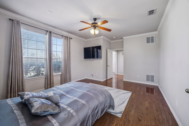 bedroom with wood finished floors, visible vents, and baseboards