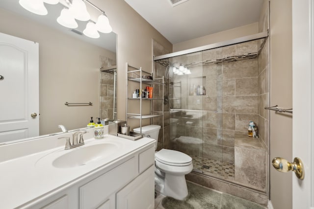 full bathroom featuring toilet, a stall shower, visible vents, and vanity