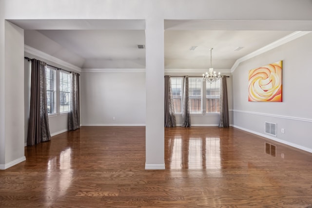 unfurnished room with crown molding, wood finished floors, visible vents, and an inviting chandelier