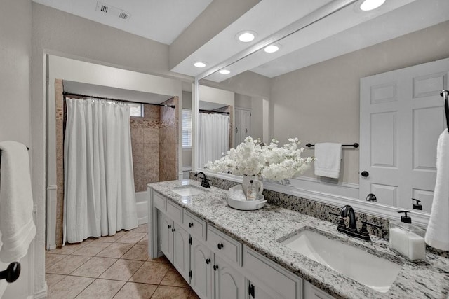 full bathroom featuring tile patterned flooring, visible vents, a sink, and double vanity