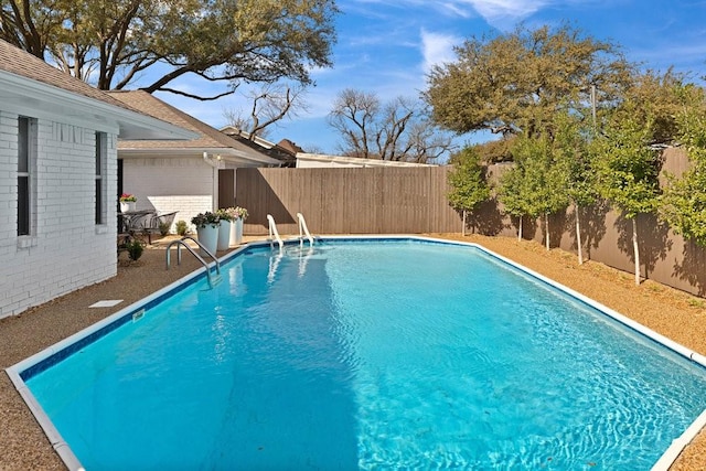 view of swimming pool featuring a fenced backyard and a fenced in pool