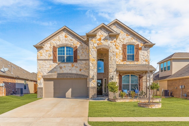 french country inspired facade with an attached garage, driveway, a front yard, and cooling unit