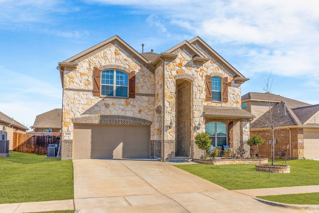 view of front of property with central air condition unit, concrete driveway, an attached garage, a front yard, and fence