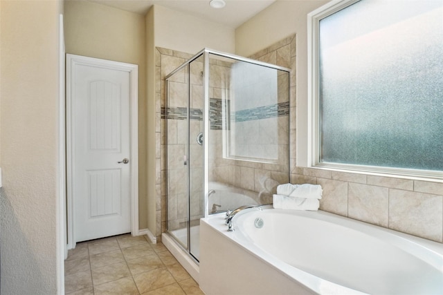 full bathroom featuring a shower stall, a bath, and tile patterned floors