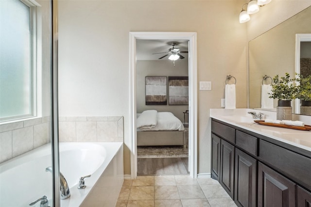 full bathroom featuring connected bathroom, ceiling fan, tile patterned floors, vanity, and a bath