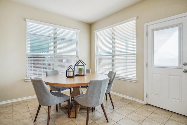 dining area with light tile patterned floors and baseboards