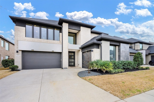 view of front facade featuring an attached garage, brick siding, driveway, and stucco siding