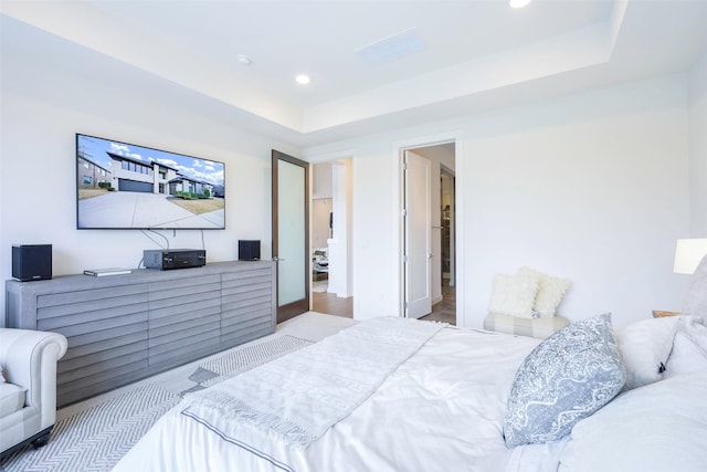 bedroom featuring recessed lighting and a raised ceiling