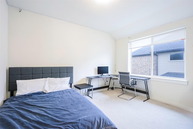 bedroom with lofted ceiling, carpet flooring, and baseboards