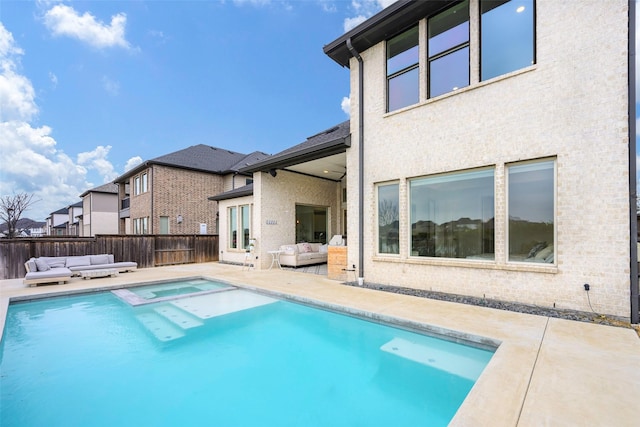 view of swimming pool featuring a patio area, an outdoor living space, and a fenced backyard