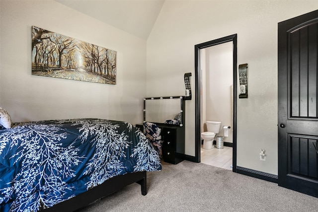 bedroom featuring carpet floors, baseboards, vaulted ceiling, and connected bathroom