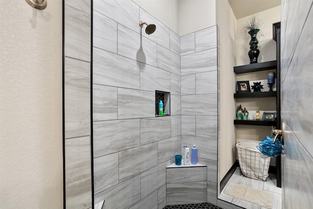 bathroom featuring a tile shower