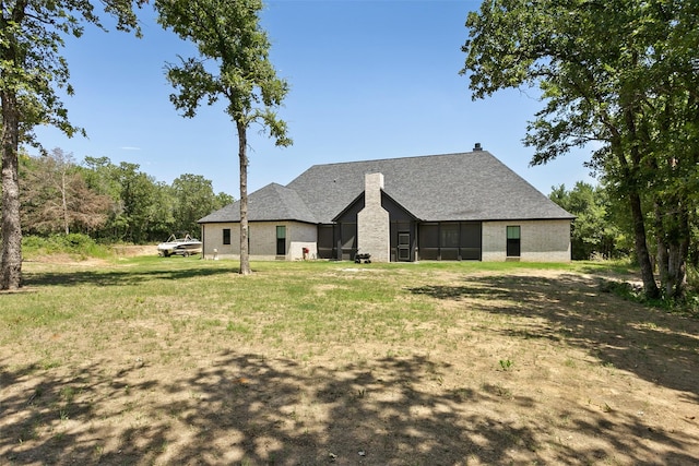 rear view of property featuring a yard