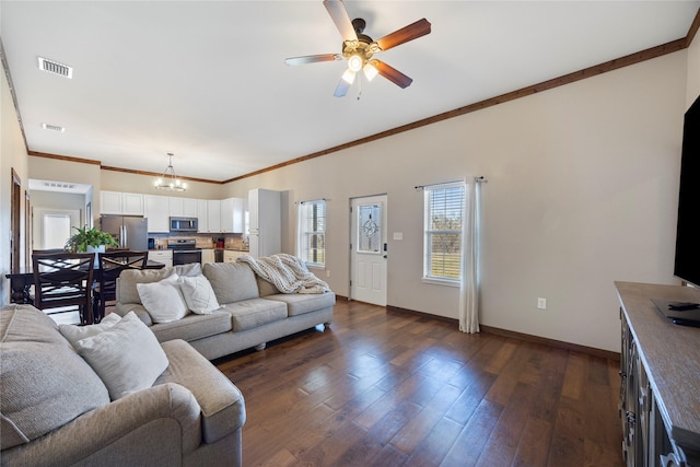 living area featuring baseboards, visible vents, ornamental molding, dark wood-style flooring, and ceiling fan with notable chandelier