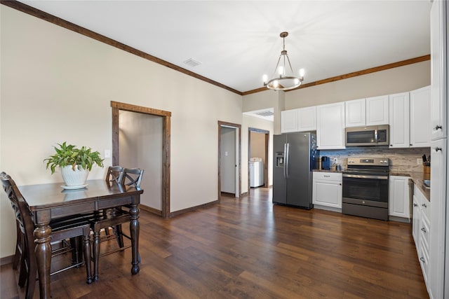 kitchen featuring tasteful backsplash, appliances with stainless steel finishes, white cabinets, and dark wood finished floors