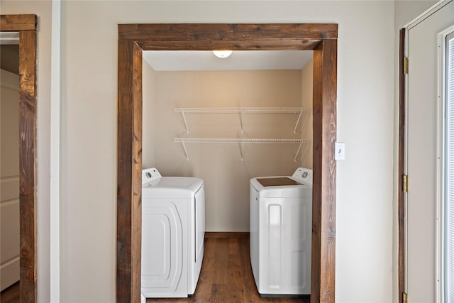 laundry room with wood finished floors, laundry area, and separate washer and dryer