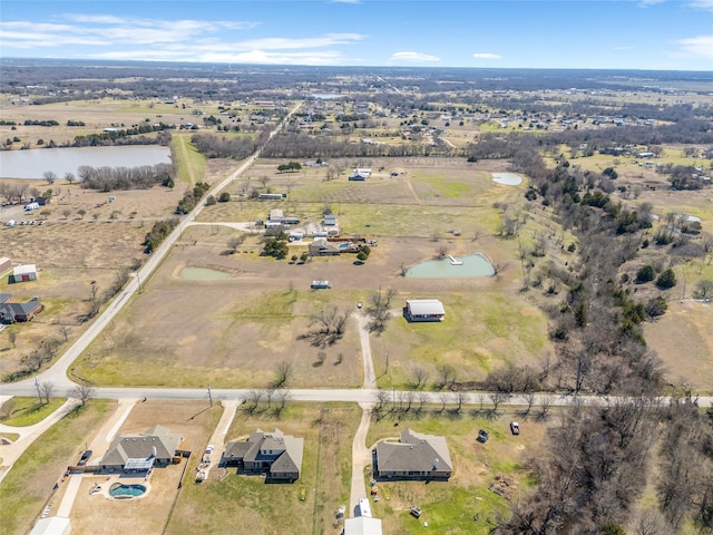 drone / aerial view featuring a water view and a rural view