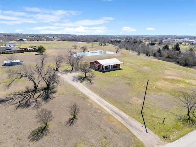 birds eye view of property with a rural view