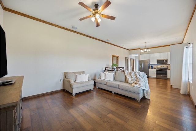 living room featuring dark wood-style flooring, crown molding, visible vents, baseboards, and ceiling fan with notable chandelier