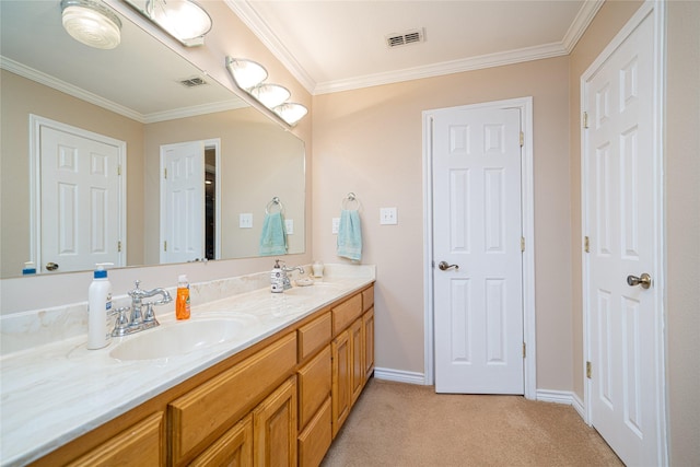 bathroom featuring a sink, visible vents, baseboards, ornamental molding, and double vanity