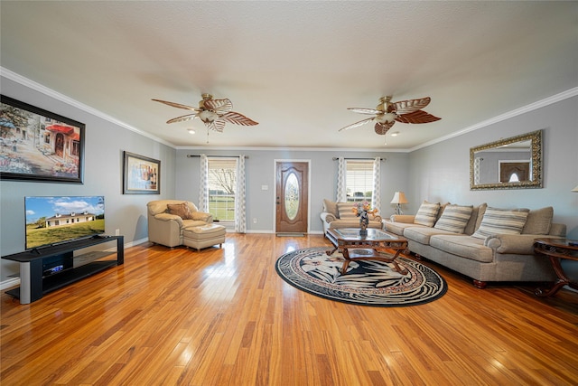 living area with plenty of natural light, a ceiling fan, and light wood-style floors