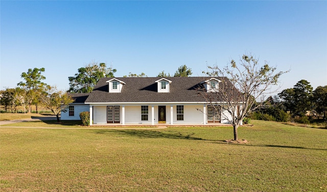 cape cod-style house with a shingled roof, a porch, and a front yard