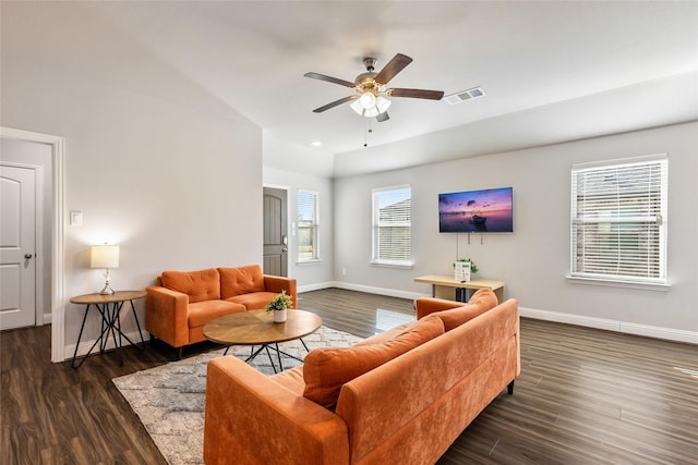 living room featuring baseboards, visible vents, ceiling fan, and wood finished floors