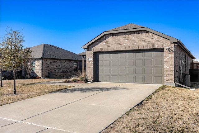 view of front of house featuring driveway, a garage, central AC unit, and brick siding