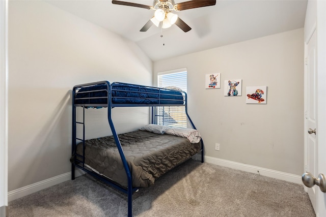 carpeted bedroom with baseboards, vaulted ceiling, and a ceiling fan