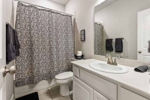 full bathroom with toilet, tile patterned flooring, and vanity