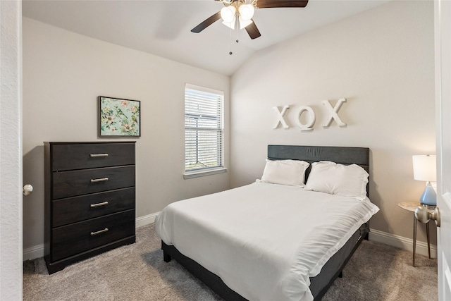 bedroom featuring carpet floors, lofted ceiling, baseboards, and a ceiling fan